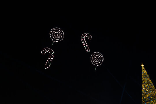 Christmas Candy Cane and Lollipop Shapes Created by UAV Drone Light Show with Soft Focus and Minimal Bokeh Effect