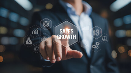 Executive Hand Touching Digital Sales Growth Interface Button with Business Icons for Strategy and Corporate Success.png