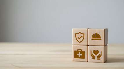 Four Wooden Cubes with Safety Icons Representing Corporate Health and Industrial Risk Management.png