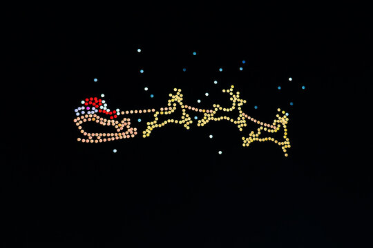 Santa Claus and Reindeer Sleigh Image Created by UAV Drone Light Show with Soft Focus and Minimal Bokeh Effect