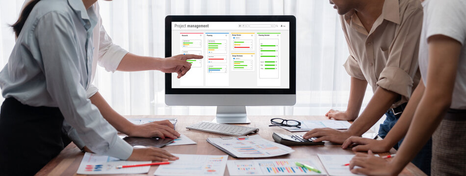 Project planning software for brisk business project management on the computer screen showing timeline chart of the team project