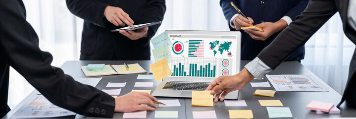 Analyst team use sticky note for creative and analytic brainstorm for business idea with BI data dashboard on laptop screen. Analysis financial data visualization tech for marketing strategy. Prodigy