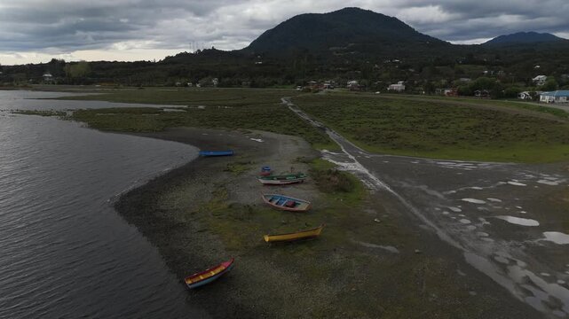 Aerial View of Colorful Wooden Fishing Boats on Coastal Bay Shore