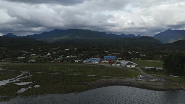 High Aerial Panorama of Coastal Village Valley and Mountains in Clouds