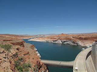 Glen Canyon Dam and Lake Powell under clear blue sky
