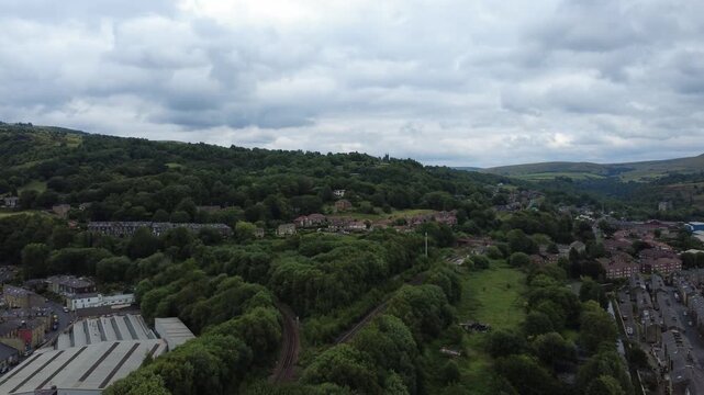 aerial drone view of the town of todmorden showing the market and streets with the railway line in the centre