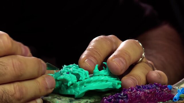 Craftsman Shaping Small Plastic Mold with Hand Chisel
