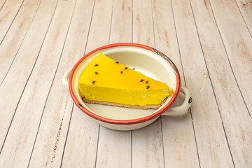 Slice of cheesecake with a chocolate brownie base, topped with salted caramel and caramelized...