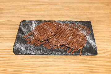 Chocolate pancakes with chocolate chips embedded in the batter, topped with a creamy chocolate...