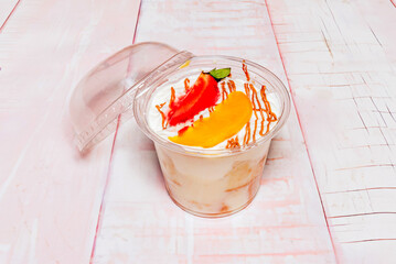 Individual serving of Tres Leches Cake served in a glass jar, showcasing the layers of soaked...