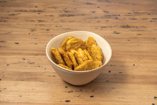a small white bowl filled with fried plantain tostones