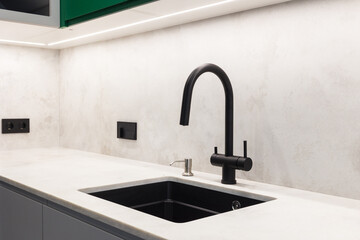 kitchen faucet on a stylish metal sink