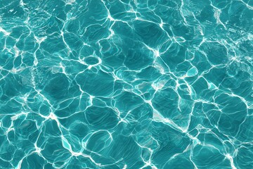 Obraz premium Clear blue water with light reflections creating a vibrant texture.