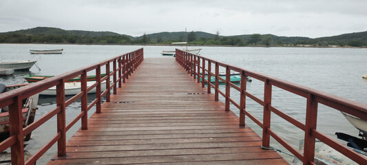 city beach sea coast lake wave water sky clouds landscape bay hill stone granite grass vegetation...