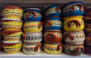 Close-up of colorful ceramic pots with traditional patterns on a shelf