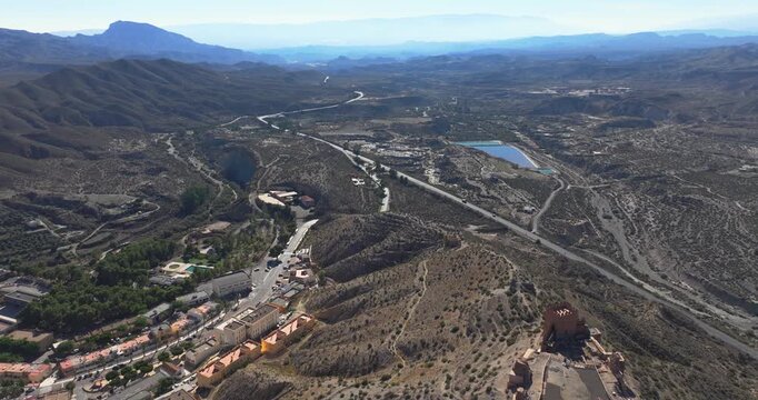 Drone panorama of ancient fortress dominating the arid Tabernas Desert landscape in southern Spain
