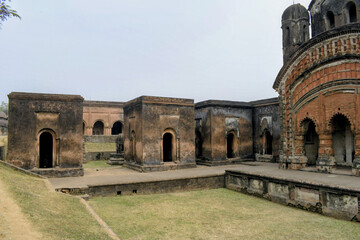the inner courtyard of the nabaratna temple complex at pathra, showing aligned shrine chambers, raised platforms, and the circular temple wall revealing spatial planning and ritual movement