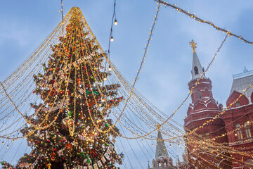 Moscow, Russia, 29 December 2025 Large Christmas tree with string lights near Red Square with historic buildings in the background,