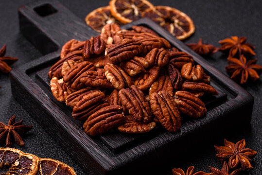 Peeled and roasted pecan nut as an ingredient for healthy food. Pecan nut as a food background