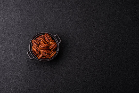 Peeled and roasted pecan nut as an ingredient for healthy food. Pecan nut as a food background