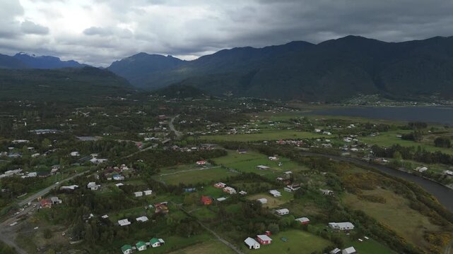 Aerial High Panorama of Mountain Valley Village and Epic Stormy Clouds