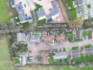 Interesting drone UAV view of an established affordable and council homes seen within a British cul de sac development. Newer, retirement bungalows can be seen at the top.