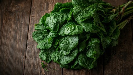 Fresh Green Leaves Arranged on a Wooden Surface in a Kitchen Setting During Daylight Hours
