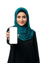 Happy young woman in a stylish teal hijab presents a cutting-edge smartphone featuring a clear blank screen, perfect for your app or message