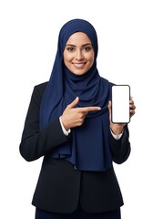 Smiling professional Arab woman in a dark blue hijab and business attire confidently presents a modern smartphone with a blank screen, perfect for showcasing digital content or mobile applications