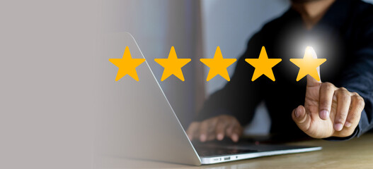 five-star rating concept with glowing star and user interaction on laptop for customer feedback and review system