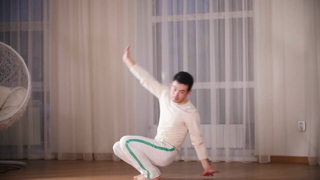 Martial arts. Capoeira. A professionalman performs an capoeira swing and turns over leaning on hands
