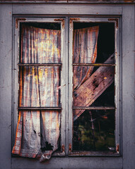 Broken Old Window with Cracked Glass and Weathered Frame