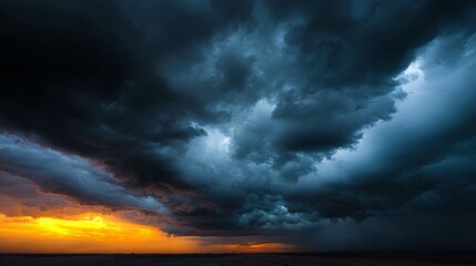 Dramatic storm clouds gathering over sunset horizon