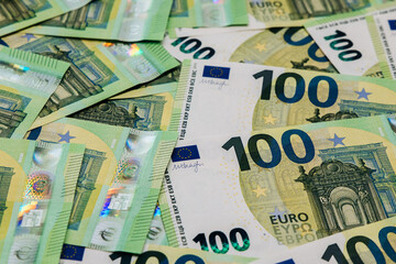 Obraz premium Close-up view of scattered euro banknotes featuring intricate designs and vibrant colors, showcasing the value and beauty of currency in a financial context