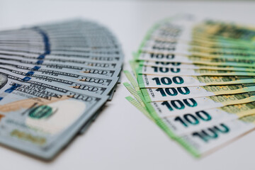 Stacks of various currency notes, including US dollars and euros, arranged artistically on a clean surface, showcasing financial diversity and economic concepts