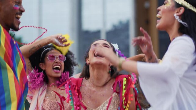 Joyful friends celebrating Brazilian Carnival in colorful costumes on a vibrant street. Happy group enjoying the festive energy of traditional Carnaval in Brazil