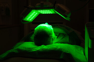 Woman getting facial treatment with led therapy.