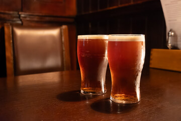 Classic London pub crawl with friends, enjoying cask ales and lively atmosphere of traditional British pubs, grasses of cask ales beer from barrels