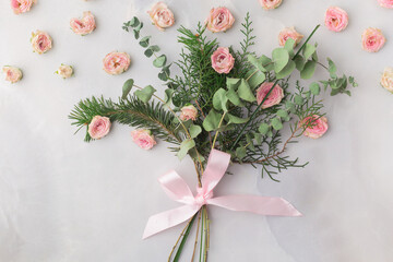 Christmas bouquet decorated with rose petals and satin ribbon &mdash; warm romantic aesthetic