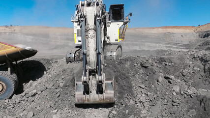 Process of extracting and loading minerals with giant excavators into mining dump trucks © WILL PHOTOGRAPHY