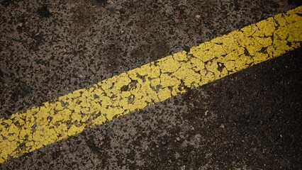 yellow paint on asphalt