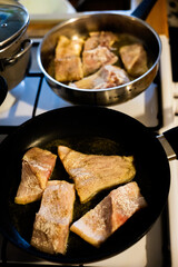Frying carp fish in a pan as a traditional Polish Christmas Eve dish prepared at home