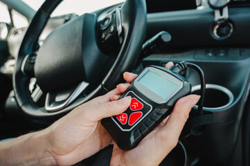Woman using OBD2 diagnostic scanner. 
