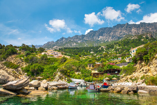 Magganitis fishing village harbor marina port cityscape, boats ships by coast shore cafe restaurant on Ikaria island, Greece Greek longevity blue zone