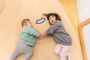 マンションのキッズルームで遊ぶ日本人の小さい姉弟