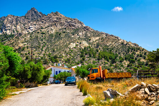 Karkinagri, Greece village mountain peak and agriculture landscape in summer farm with house villa trees and tractor in blue zone of Ikaria island