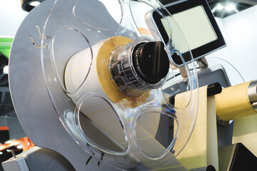 Fragment of a conveyor belt of a paper labeling machine. Packaging industrial background.