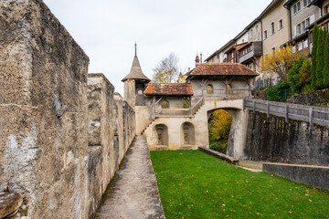 Gruyeres Castle entrance bastion and stone wall fortifications in autumn. Gruyeres, Canton of Fribourg, Switzerland.