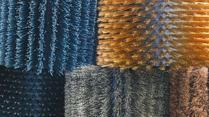 A collection of cylindrical cleaning brushes in a variety of colors and textures. The concept of variety and versatility in brushes.