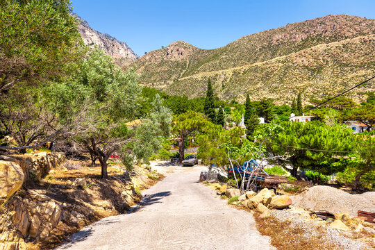 Karkinagri, Ikaria island Greece with Atheras mountain range cliffs in summer by small farm house home with olive tree garden in North Aegean